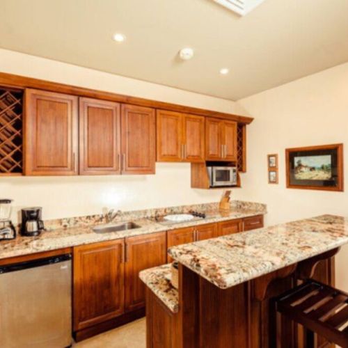 This kitchenette comes equipped with granite counter tops, a microwave, coffee maker, small fridge and stove top.