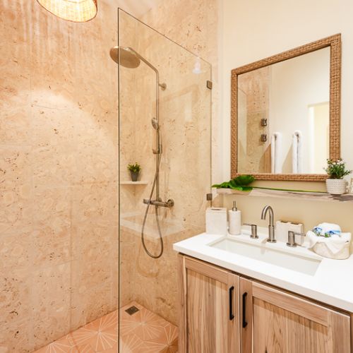Secodn batrhoom with a shower and hot water, all remodeled with elegant amenities.