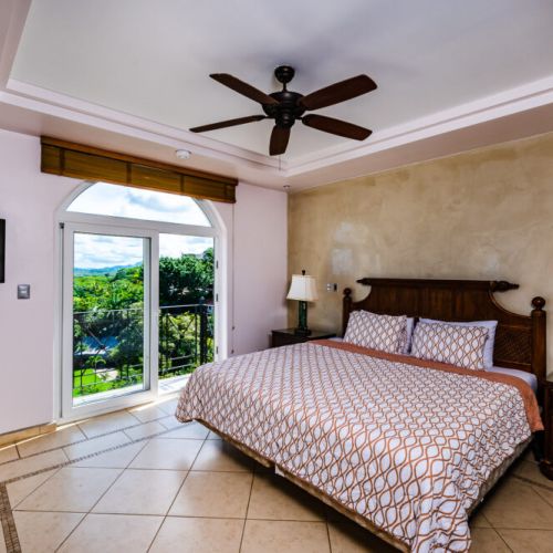 Master bedroom with a king-size bed and ocean view