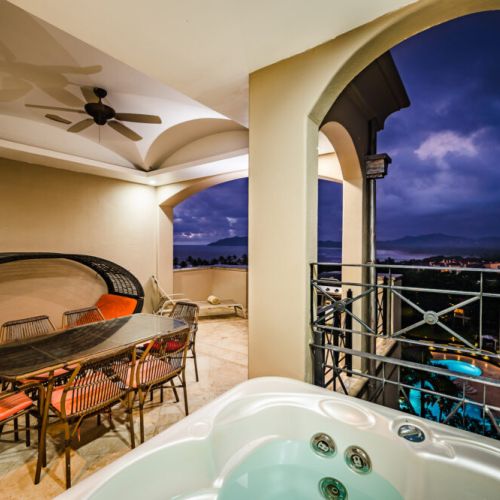 The top balcony with a jacuzzi and a view of the ocean.