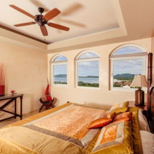 This bedroom is furnished with a king bed and has breathtaking ocean views.