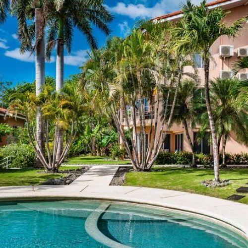 Enjoy the pool surrounded by bermuda grass gardens