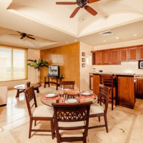 The second floor of this condo has a second kitchen, living area, and dining table.