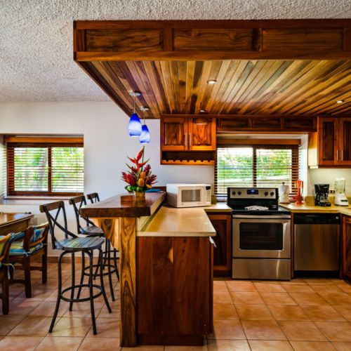 This bright kitchen combines rustic and modern styles. It comes fully equipped with a large fridge, electric stove and oven, a dishwasher, coffee maker and blender
