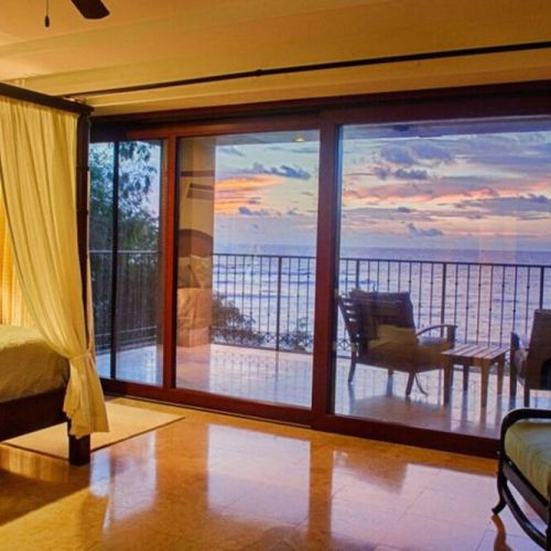 A breathtaking view of the sunset over the ocean is just a step away.